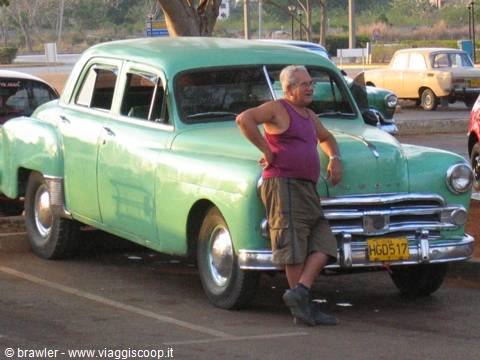 Man leaning on a vintage green American car, Havana