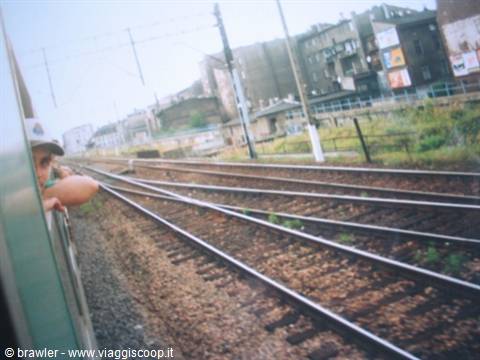 Child leaning out of the train window arriving at the station