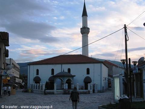 White mosque with minaret in Ohrid pedestrian square at dusk