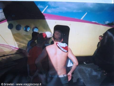 Tourists boarding a white and pink seaplane