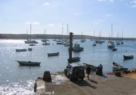 Sailboats moored in Puerto Deseado bay, vehicle on the dock