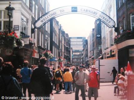 Crowd of tourists under the Welcome to Carnaby Street sign in London