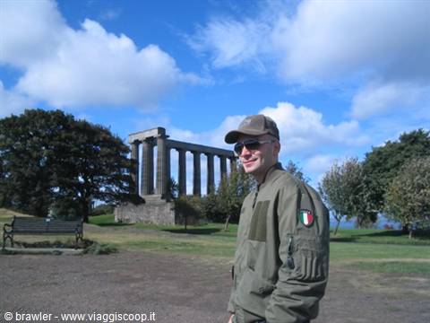 Smiling tourist in front of the National Monument atop Calton Hill
