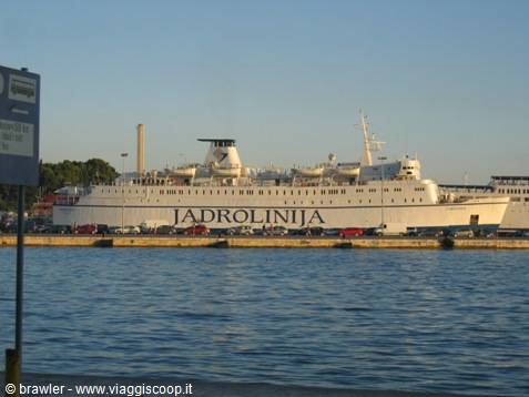 White Jadrolinja ferry docked at the harbor in sunlight