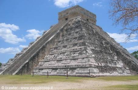 El Castillo pyramid at Chichén Itzá under a blue sky with clouds