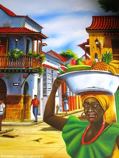 Painting of fruit vendor balancing bowl among Cartagena colonial houses
