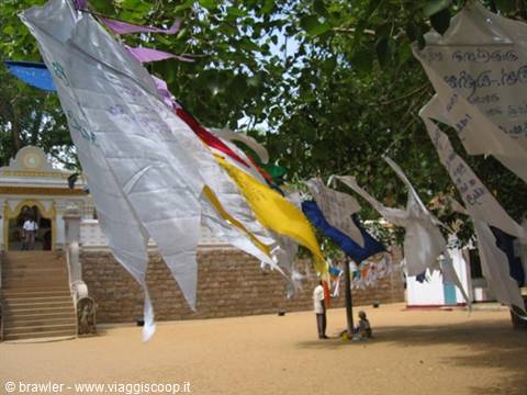Prayer flags fluttering before the white temple at Anuradhapura