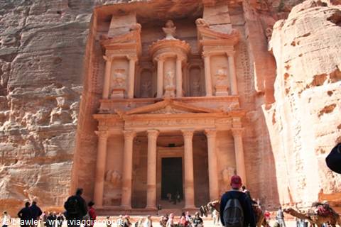 Tourists and camels in front of Petra's Treasury, facade carved in rose rock