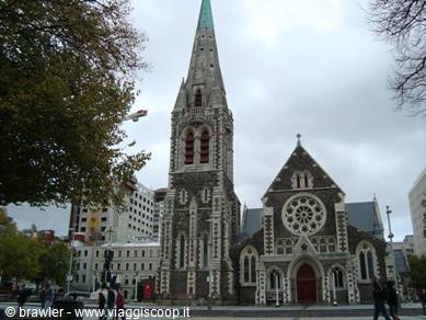 ChristChurch Cathedral stone facade with spire and rose window, cloudy sky