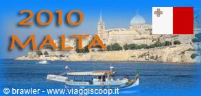 Tour boat in front of Valletta's walls and domes