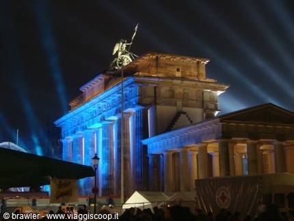Brandenburg Gate lit in blue with light beams at night in Berlin