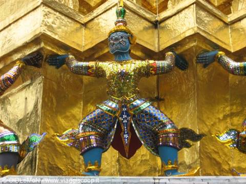 Colorful yaksha demon statue supporting the golden temple base, Wat Phra Kaew