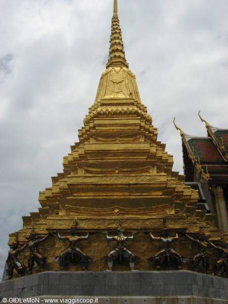 Golden stupa of Wat Phra Kaew in Bangkok with Yaksha demon statues at base