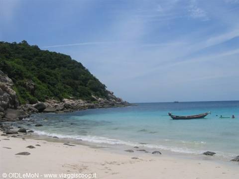 Wooden longtail boat on white sand beach at Ko Lipe