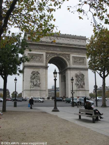 Arc de Triomphe in Paris, stone arch with street lamps, bench and autumn trees