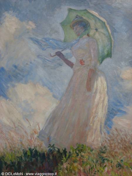 Monet painting: woman in white with green parasol against cloudy sky