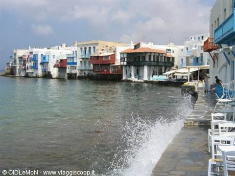 Colorful houses over the sea, waves splashing the walkway, Little Venice, Mykonos