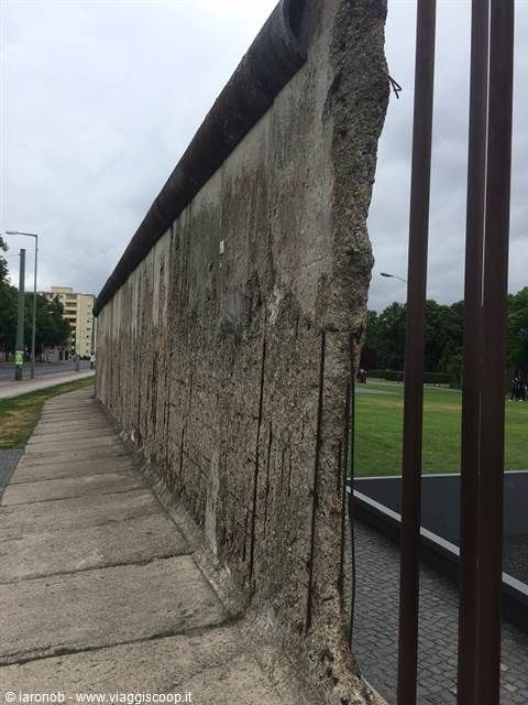Segment of the Berlin Wall in concrete under a grey sky