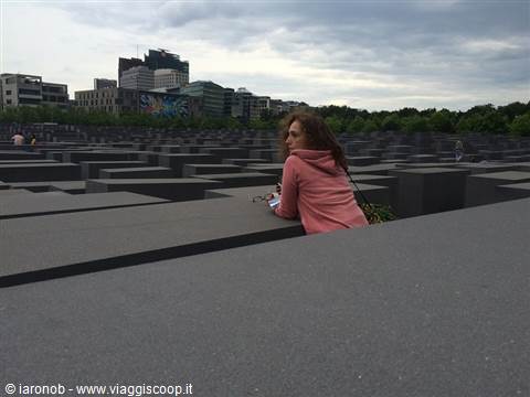 Woman leaning on the concrete stelae of the Holocaust Memorial in Berlin