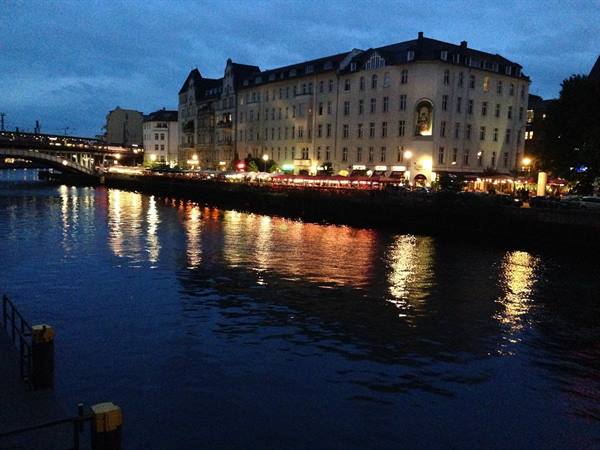 Berlin: Spree river at night, restaurant lights reflecting on dark water