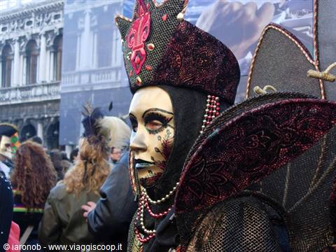 Golden mask and brocade costume at Venice Carnival in St Mark's Square