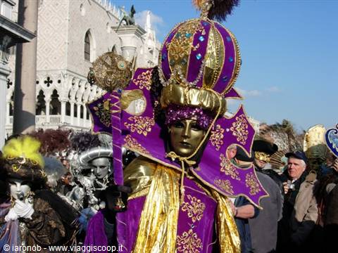 Venice Carnival: purple and gold velvet costume in front of Doge's Palace