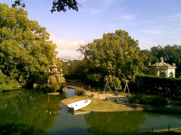 White boat and bridge on the pond in Funchal's Vignola park