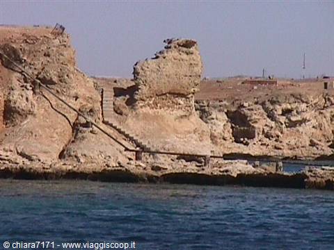 Staircase carved into limestone rock above the turquoise sea