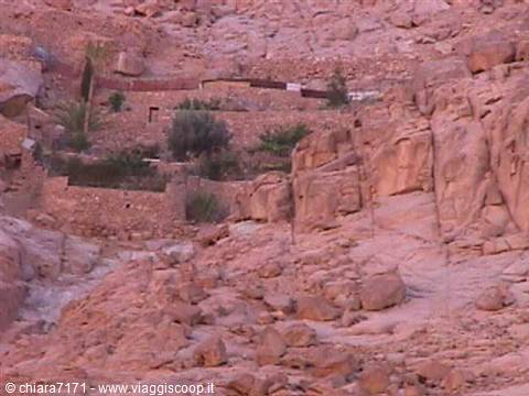 Stone walls and hidden gardens among the red rocks of Saint Catherine