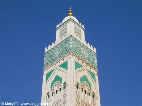 Hassan II Mosque minaret, green and white mosaic tiles against blue sky