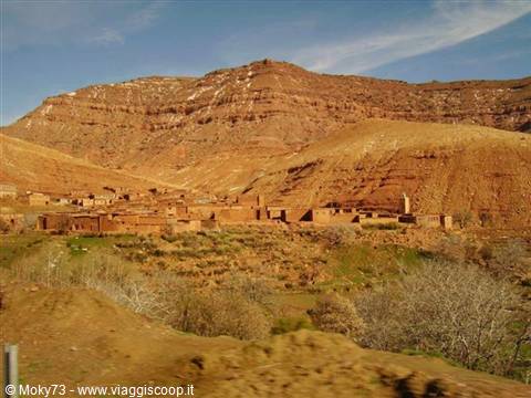 Mud-brick village at the foot of the red Atlas mountains, Morocco