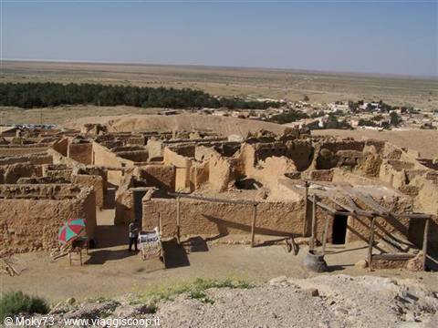 Ancient earthen ksar with workshops and umbrellas among the courtyards