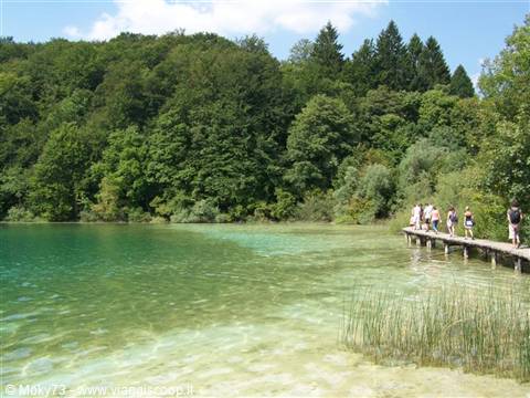Tourists on wooden walkway over turquoise water, Plitvice Lakes