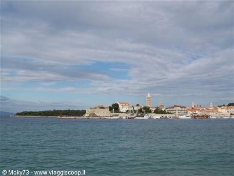 Rab old town with bell tower, boats moored on the Adriatic sea