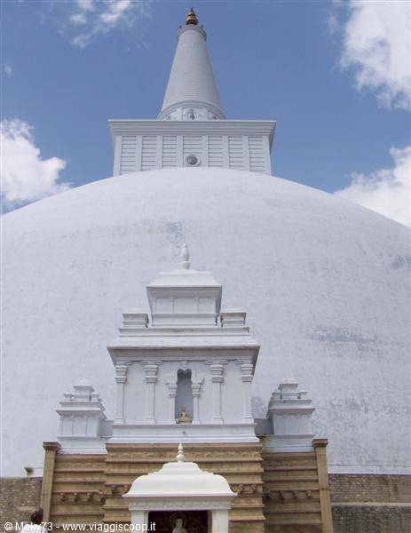 The white Ruwanwelisaya stupa in Anuradhapura against a blue sky