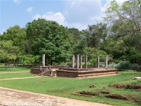 Polonnaruwa ruins: stone pillars on ancient platform amid green lawn