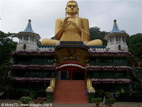 Large golden seated Buddha above the demon-mouth entrance of Dambulla Golden Temple