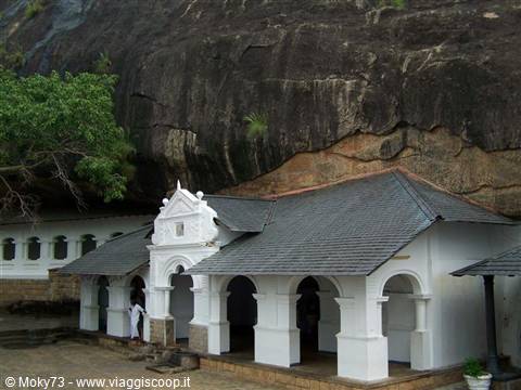 White temple with arches beneath the great rock of Dambulla