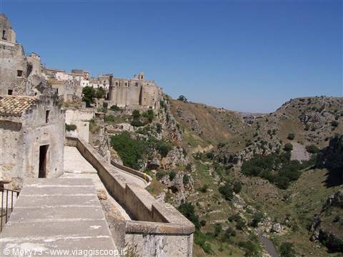 The Sassi of Matera: limestone cave houses above the ravine, sunny day
