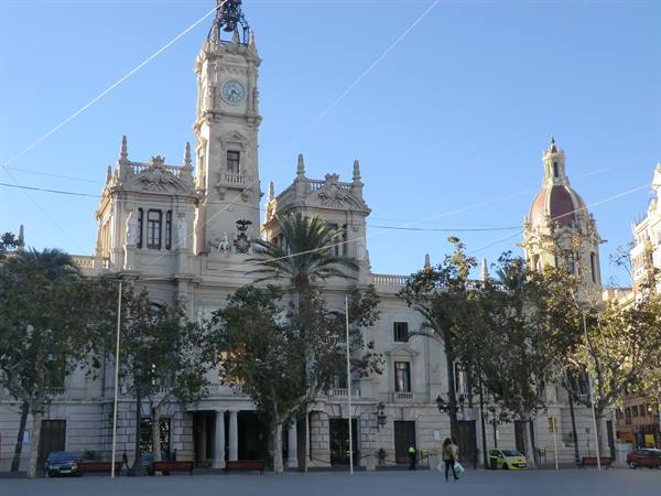 Baroque facade of Valencia's town hall with clock tower under blue sky