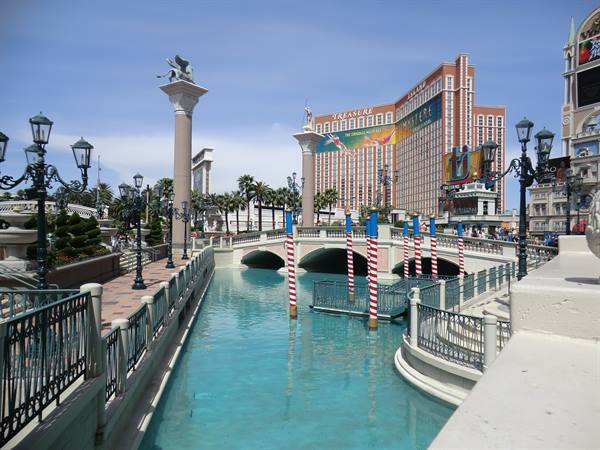 Canal with striped poles and bridge in front of the Venetian hotel, Las Vegas
