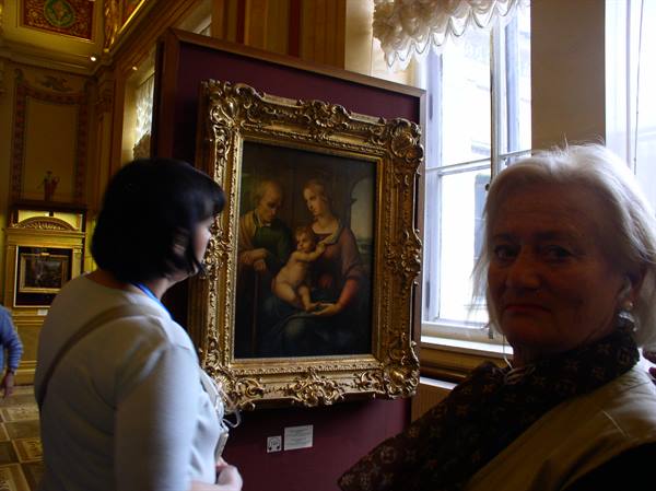 Visitors admiring a Madonna and Child in gilded frame, Hermitage