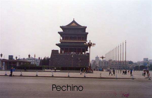 Traditional stone tower in Beijing, people walking under grey sky