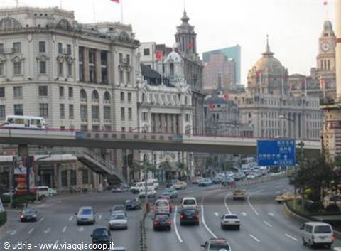 The Bund in Shanghai: heavy traffic beneath historic colonial buildings, daylight