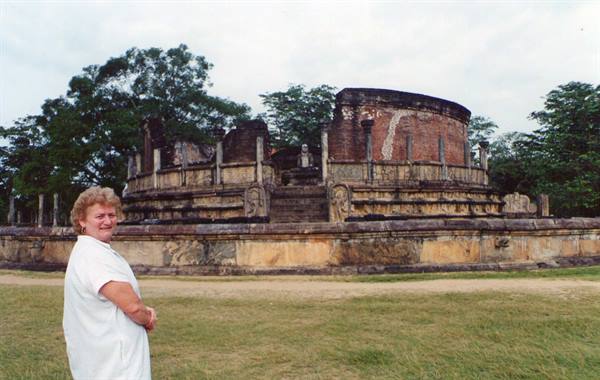 Woman in white before the Polonnaruwa Vatadage, ancient circular stone stupa