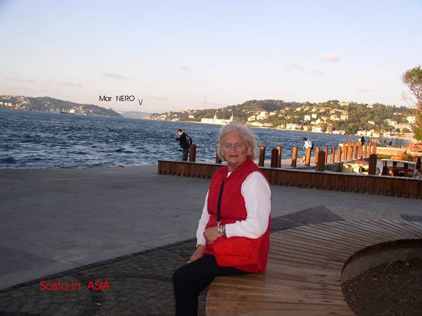 Woman sitting on a wooden bench along the Black Sea waterfront