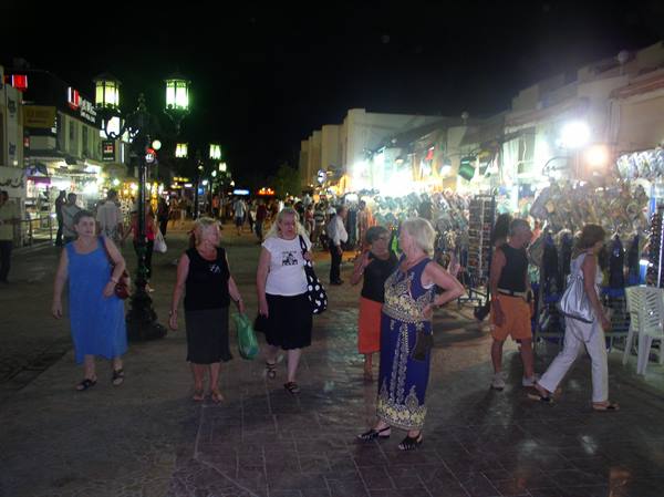 Tourists stroll through the illuminated night market street in Sharm el-Sheikh