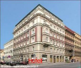 Historic neoclassical building with hotel sign on the corner