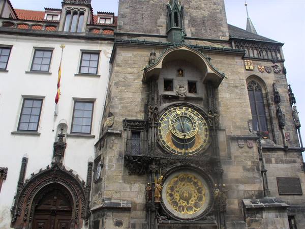 Medieval astronomical clock on the stone facade of Prague's Old Town Hall