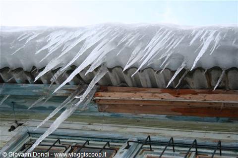 Threatening icicles hang from the roofs of the houses